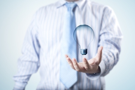 Business man with light bulb floating on his hand  Concept for idea of connectivity within grasp の写真素材