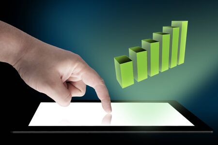 Business graph coming out from tablet PC  Concept for using table for businessの写真素材