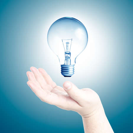 Light bulb in floating on Man s hand  Concept for new ideasの写真素材