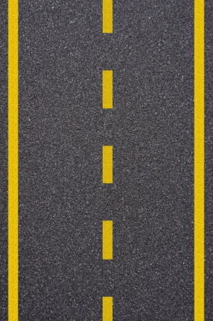 Asphalt road texture with yellow stripeの写真素材
