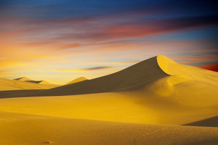 Desert sand dune on sunset skyの写真素材
