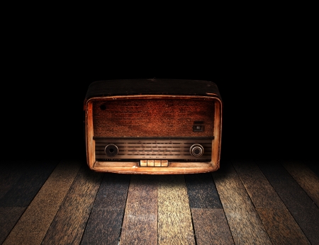 Old room with wooden floor and vintage radio with fade to black backgroundの写真素材