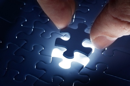 Missing jigsaw puzzle piece with light glow, business concept for completing the final puzzle pieceの写真素材
