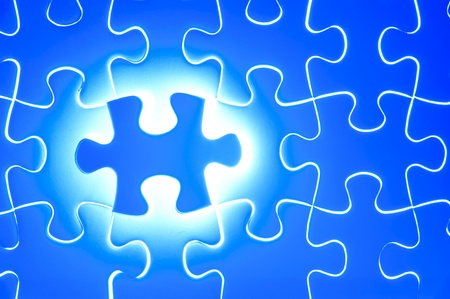 Missing jigsaw puzzle piece with light glow, business concept for completing the final puzzle pieceの写真素材
