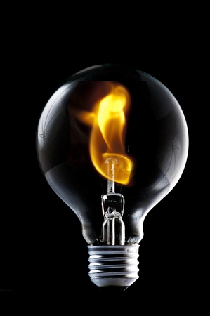Fire and smoke in side the light bulb  Concept for energy consumption and environmental awareness の写真素材