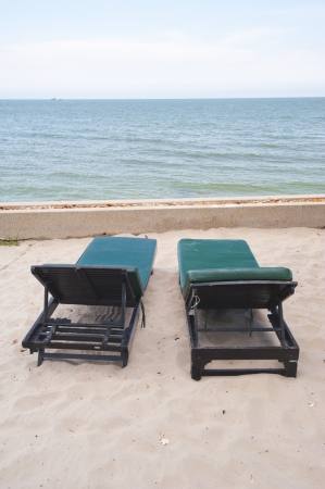 Colorful beach chairs on the white sand beach with cloudy blue sky の写真素材
