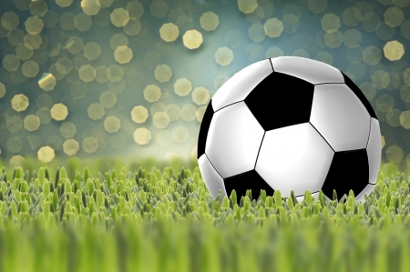 Soccer ball on green grass with bokeh backgroundの写真素材