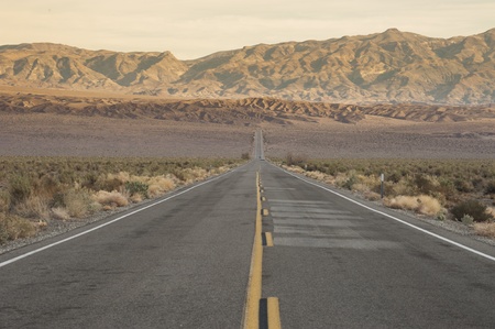 Road in desert leading to the mountainの写真素材