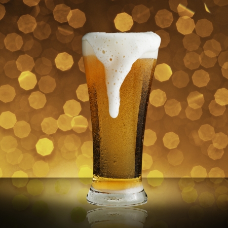 Glass of beer with beautiful bokeh backgroundの写真素材