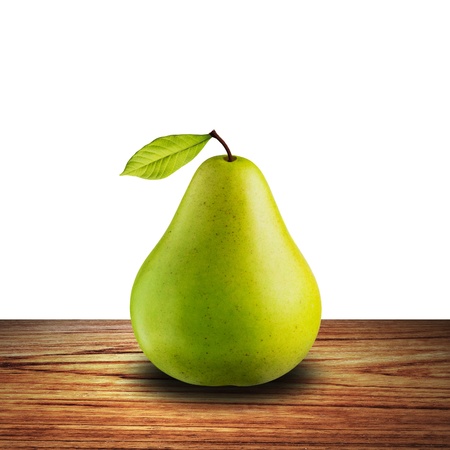 Green pear on wood table with white backgroundの写真素材