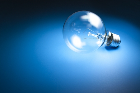 Light bulb on blue backgroundの写真素材