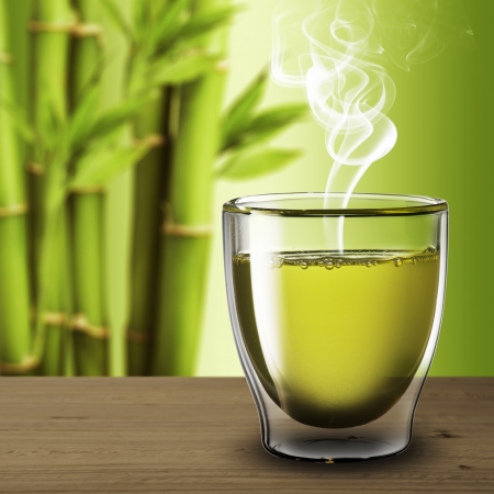 Glass of green tea on wood table with bamboo backgroundの写真素材