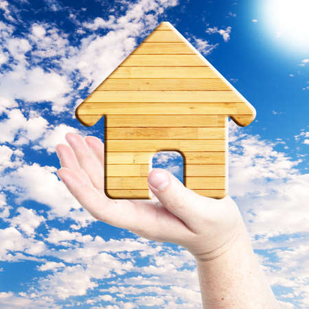 Wood house symbol on hand  Concept for building houseの写真素材