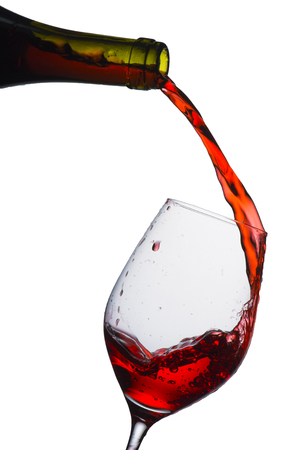 red wine pouring into glassの写真素材