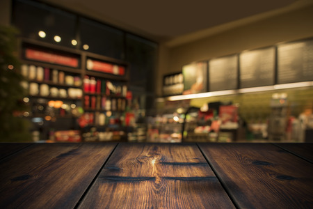 Wood Table With Coffee Shop View In Backgroundの写真素材