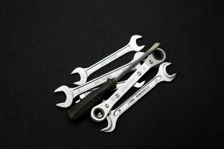 wrench and screw driver in black background