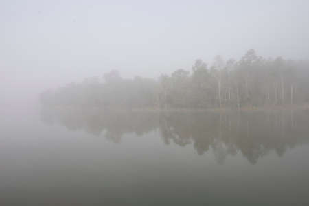 "Khaoyai National part" A thick early morning fog on this lake in Khaoyai Park, In Thailand.の写真素材