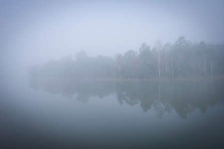 "Khaoyai National part" A thick early morning fog on this lake in Khaoyai Park, In Thailand.の写真素材