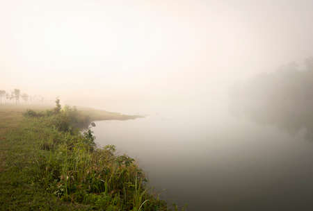 "Khaoyai National part" A thick early morning fog on this lake in Khaoyai Park, In Thailand.の写真素材