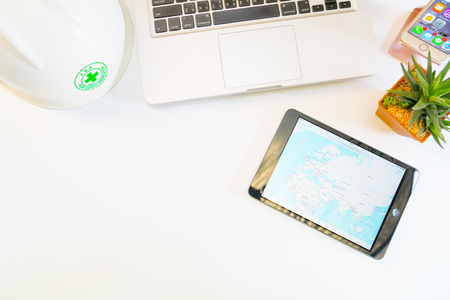 Bangkok,Thailand March 4 2017 : Notebook and safety helmet and iPad mini with social network service Google amp on the screen. iPad was created and developed by the Apple inc.のeditorial素材