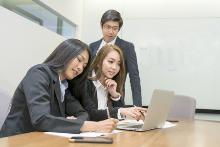 Young aged Asian business team meeting in office wiht laptop and mobile.の写真素材