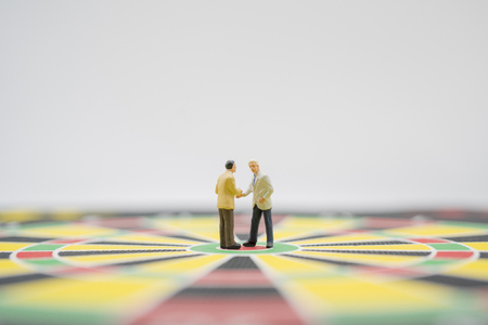 MIniature toy.Business man stand on dart port shake hand or discuss about business planning.Business,financial,business growth,business planning ,business target concept.の写真素材