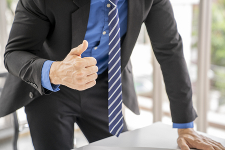 boss thumb up to colleague in meeting room.の写真素材