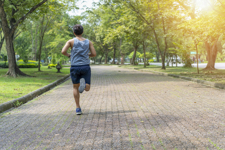 Sporty man jogging or exercise in national park on early morning .Sport concept.の写真素材