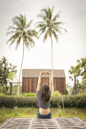 young woman sit and relax in beautiful nature resort.の写真素材