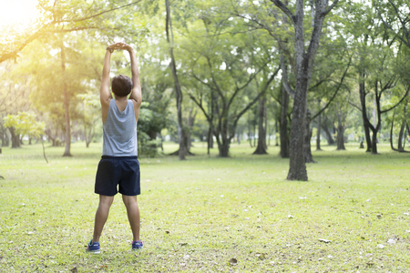 Sporty man jogging or exercise in national park on early morning .Sport concept.の写真素材
