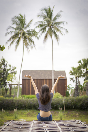 young woman sit and relax in beautiful nature resort.の写真素材