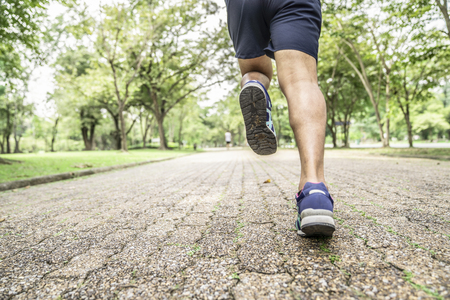 Sporty man jogging or exercise in national park on early morning .Sport concept.の写真素材
