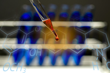 Scientist or doctor dripping chemical liquid to glassware containing test tube,science research concept.の写真素材