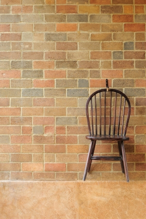 Red brick wall and chair on the wall の写真素材