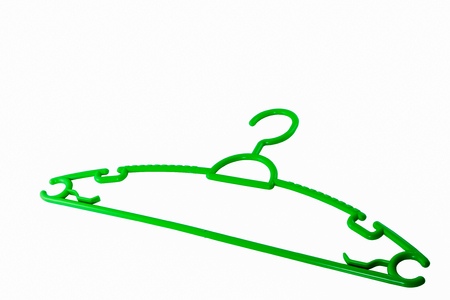 green plastic hanger isolated on whiteの写真素材