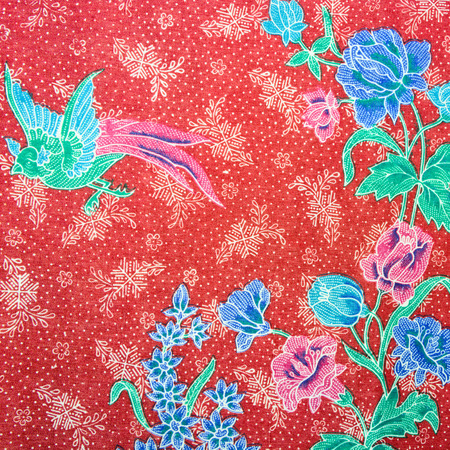 Closeup of retro tapestry fabric pattern with classical image of the colorful flowers and birds on blue backgroundの写真素材