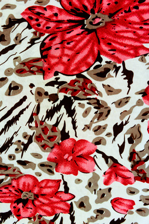 texture fabric of tiger prints and decorative rosesの写真素材