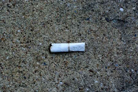 Old cigarette butts being left on the cement floor