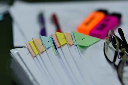 The file not that is placed on the desk a mess. Indicative of a lot of work. Messy workplace with stack of paper on tableの写真素材