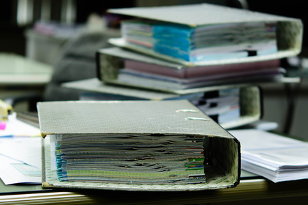 The file not that is placed on the desk a mess. Indicative of a lot of work. Messy workplace with...