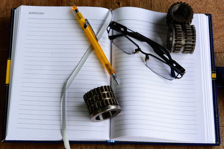 Metal Car Parts Notebook, pencil, calculator, eyeglassesの写真素材