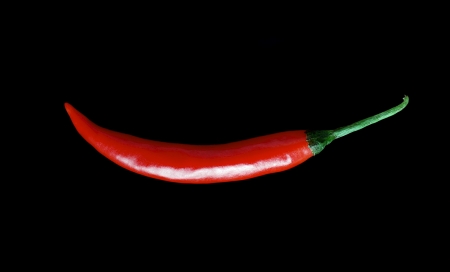 Fresh red hot chili peppers  isolated on a black background