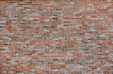 red brick wall or old dark brown, orange brick fences, grungy rusty blocks of stone work for texture and backgroundの写真素材