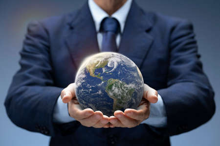 Businessman hold Global World. Planet Earth in hand of business man show Global warming, Save...