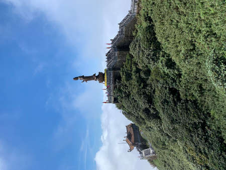 Pagoda on top of a hill with green trees and blue skyの写真素材