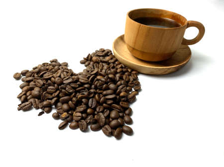 Coffee beans and a cup of coffee on a white backgroundの写真素材