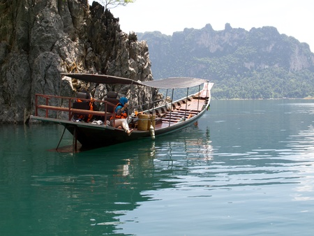 Woman on Boat and Ratchapapa Dam, Thailandの写真素材