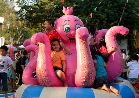Bangkok, Thailand - January 17, 2015 Unidentified children is playing a giant octopus at Lumpini Park, when the day of Thailand's travel festival.のeditorial素材