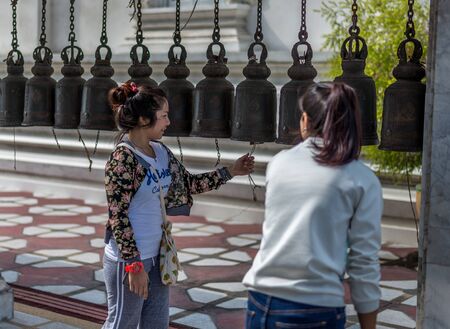 Bangkok, Thailand - Feb 14, 2015 Unidentified woman is ring the old bell in the temple. The meaning is sucessfulのeditorial素材