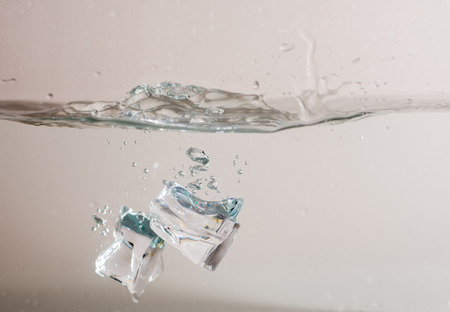 ice cube drop into waterの写真素材